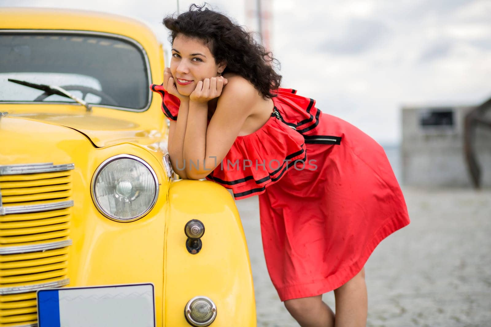 Woman in nice dress rely on yellow car
