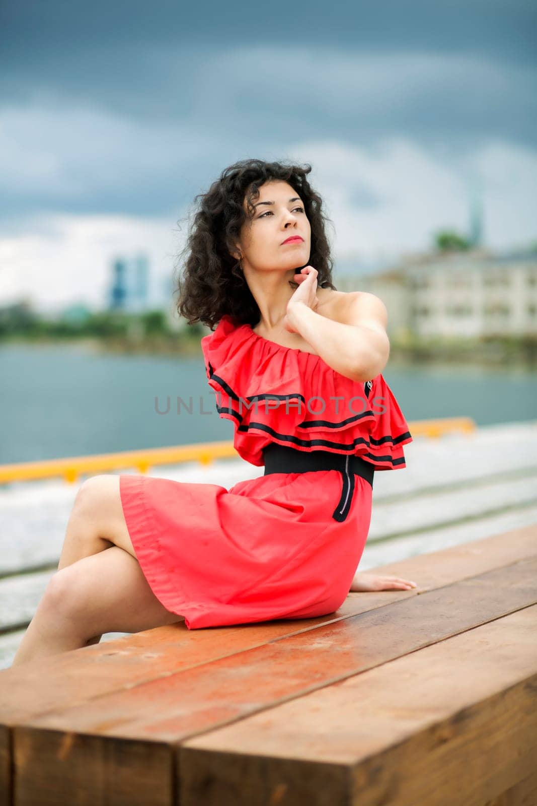 Woman in nice dress sit on wooden bench