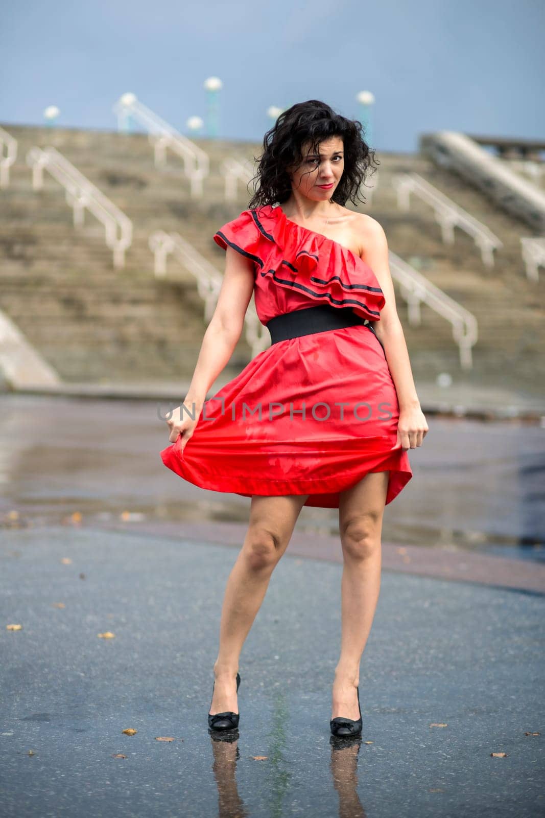Woman in nice soaking wet dress at square