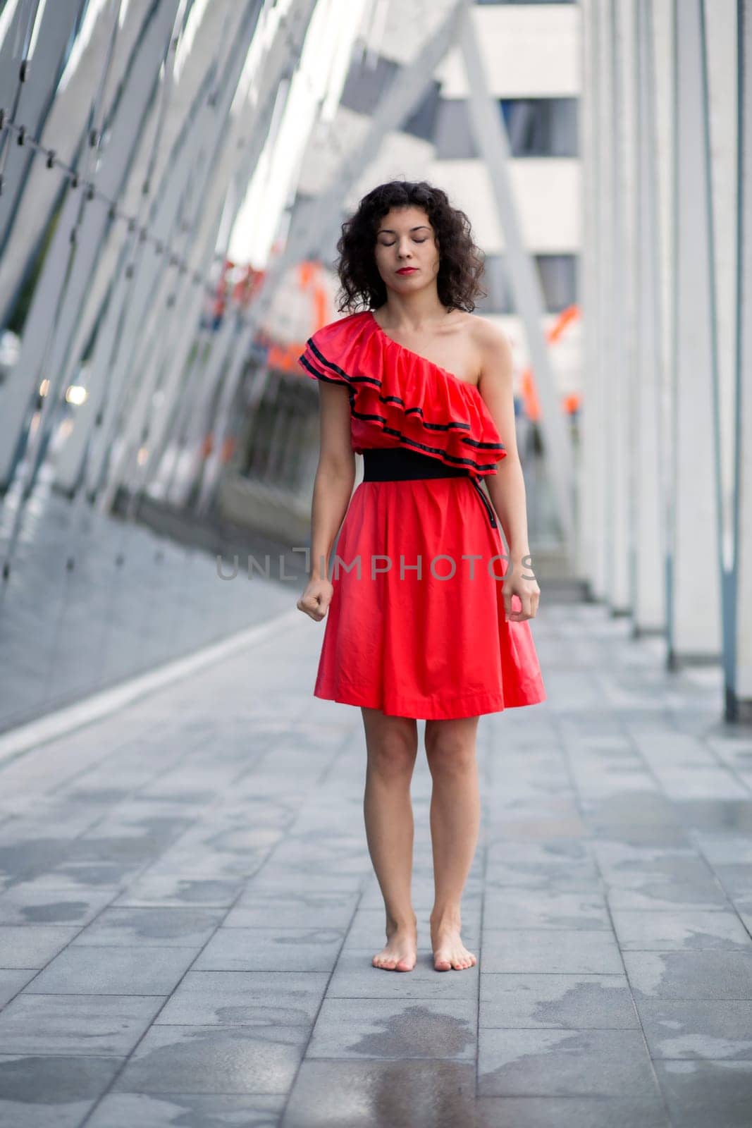 Woman in red dress stand straight on square