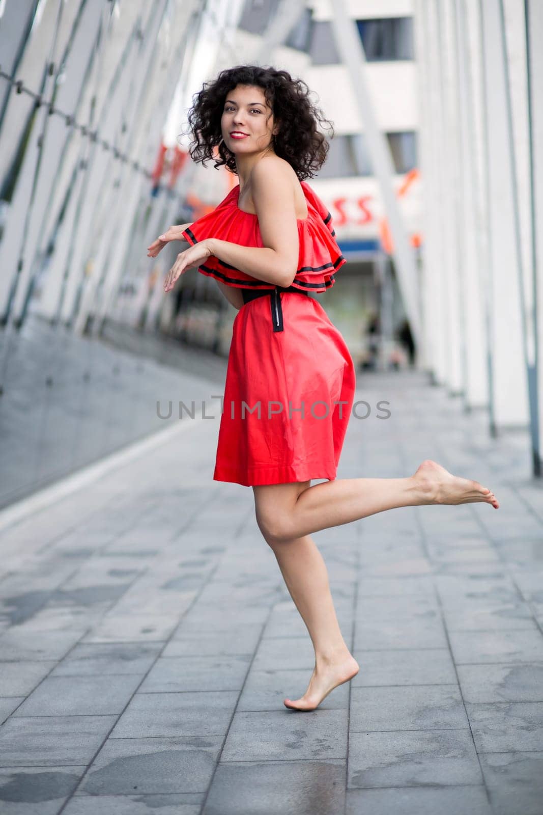 Woman in red dress mimicking run on site