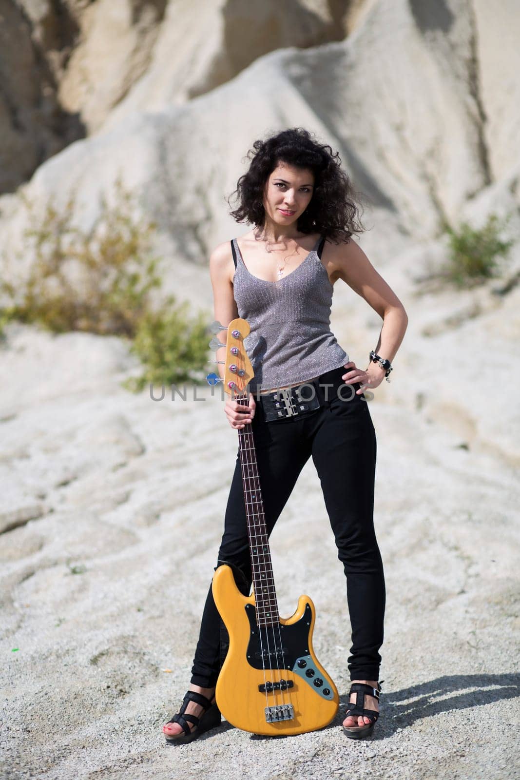 Woman placed yellow guitar on ground between legs