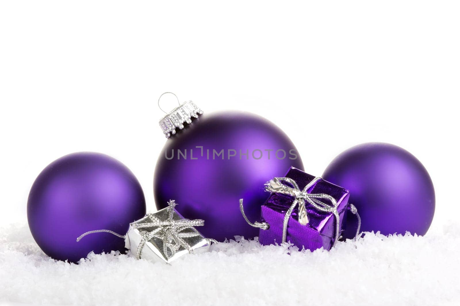 Christmas baubles purple with gifts on artificial snow