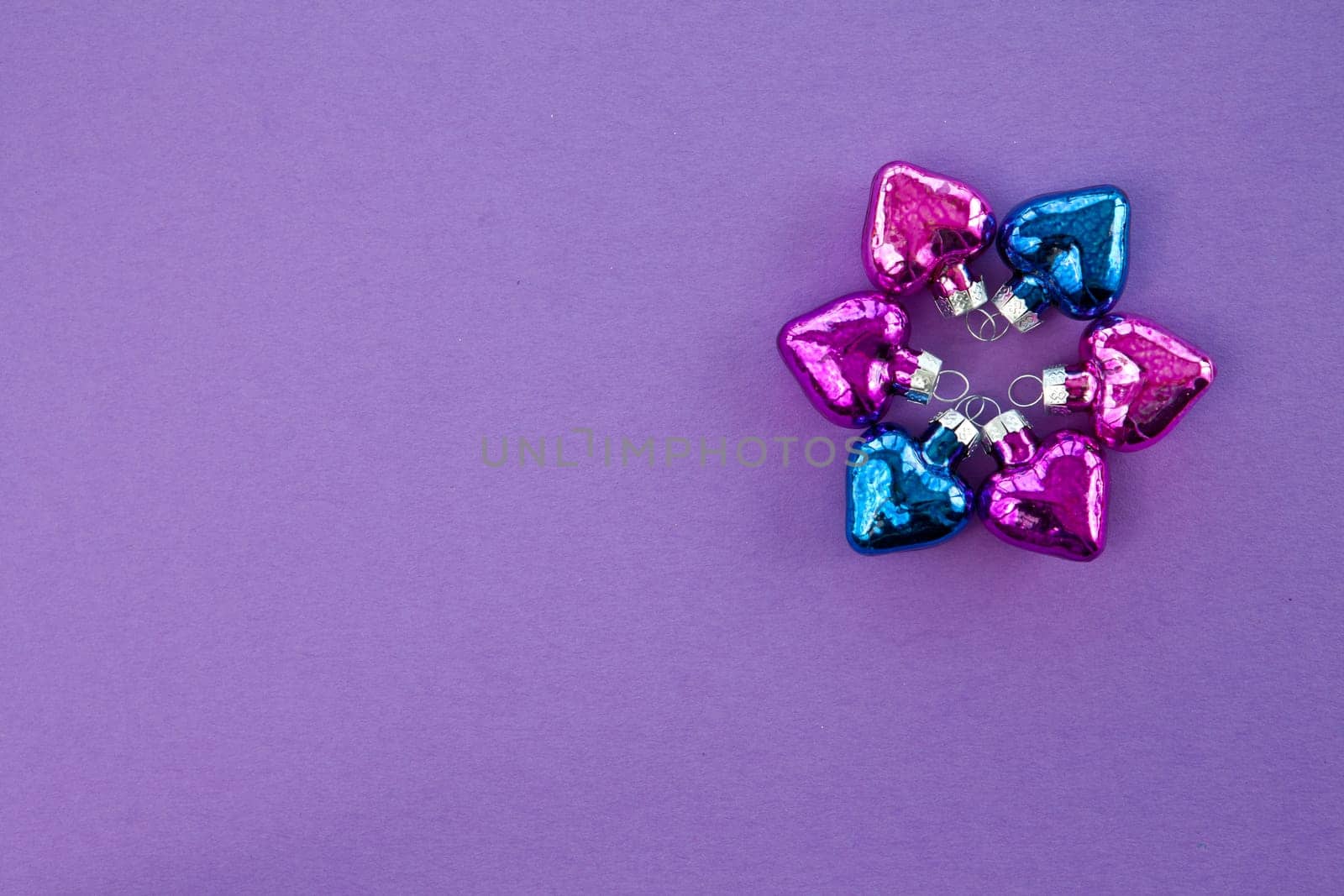 Purple background for Christmas with colorful hearts