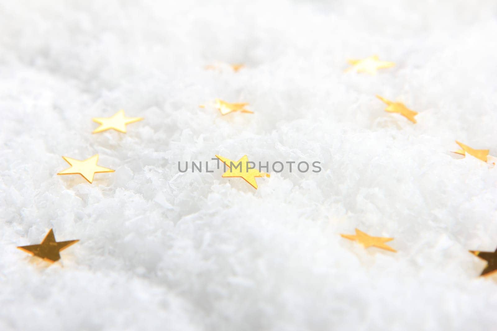 golden poinsettias on artificial snow