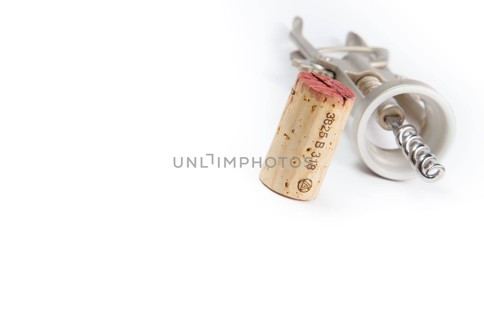Wine cork and corkscrew on white background