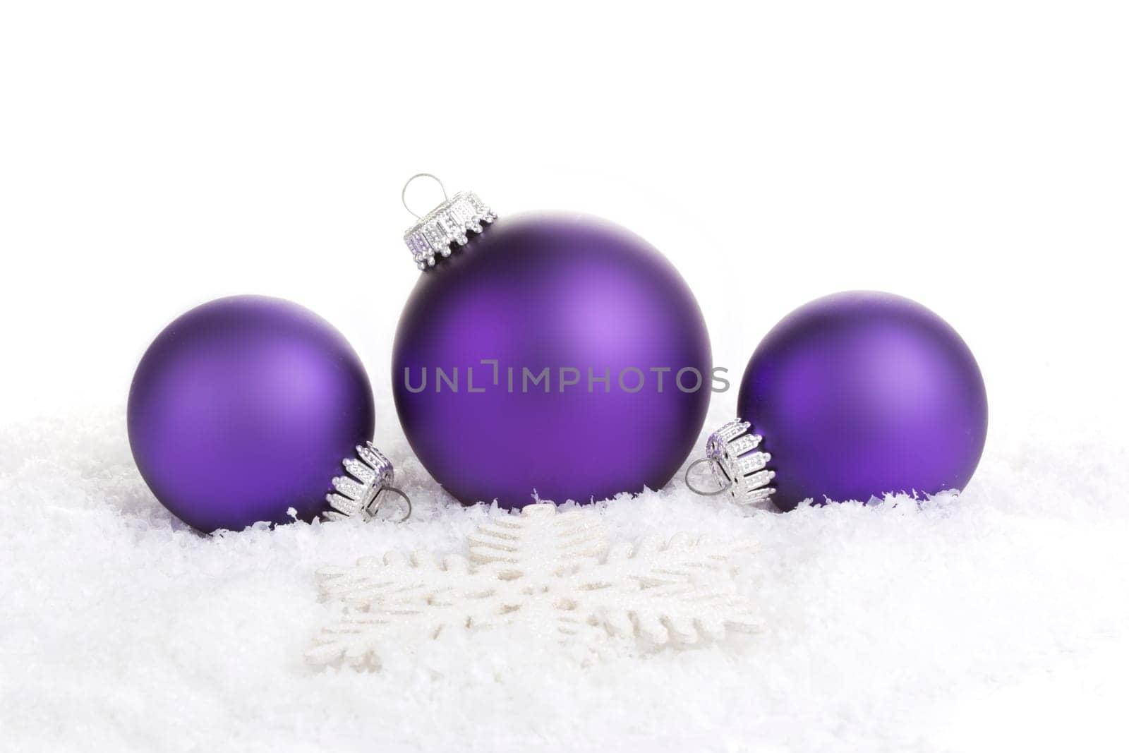 Christmas baubles purple with star on artificial snow