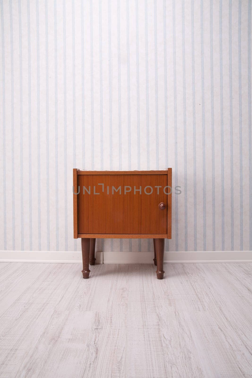 piece of furniture with old fashioned striped wallpaper