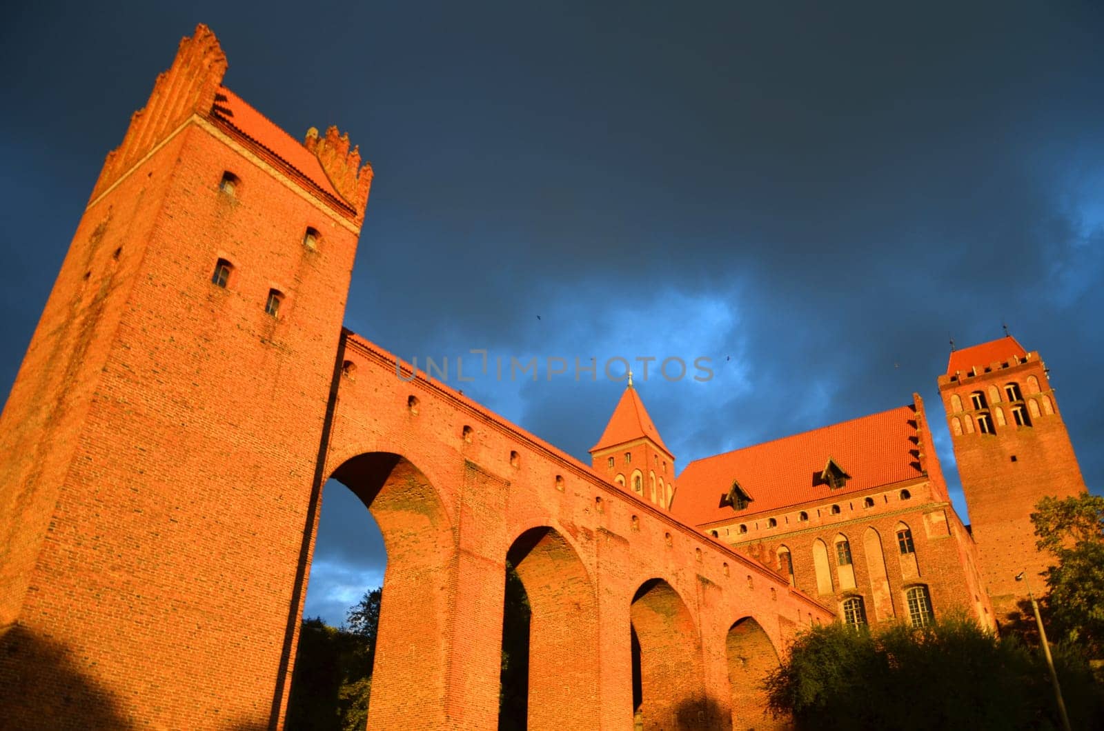 Kwidzyn cathedral in Pomerania region in Poland under dramatic gloomy rainy clouds at sunset