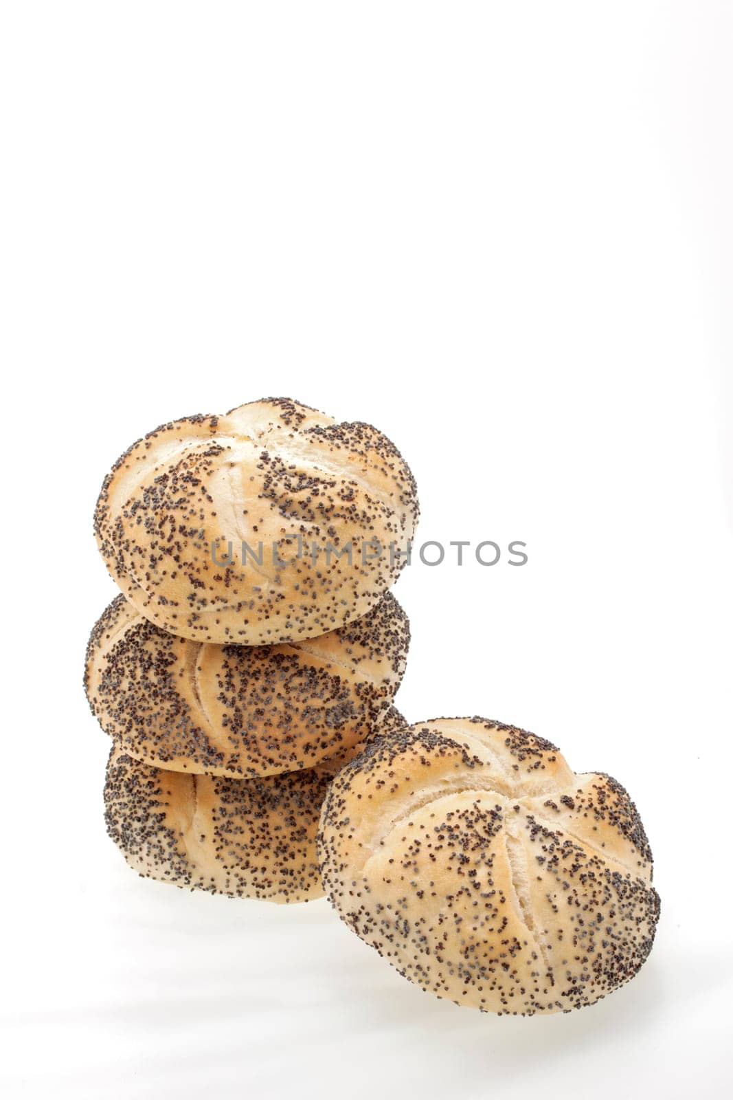 A stack of poppy seed rolls on a white background
