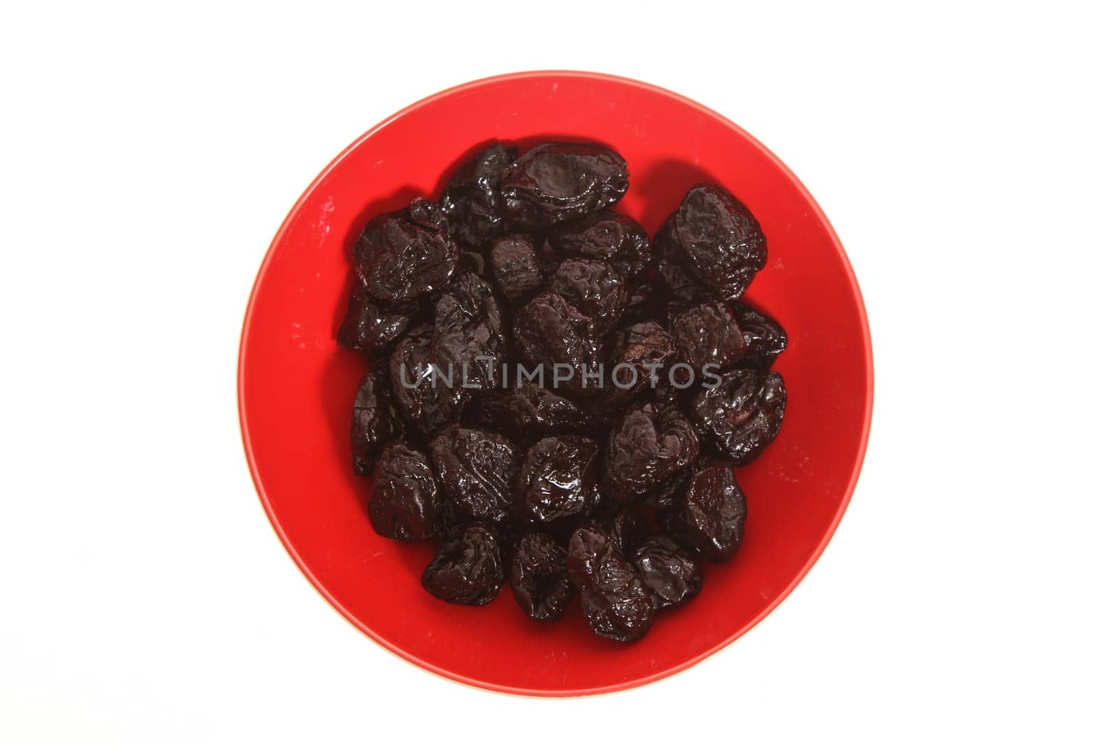 A pile of prunes on a bowl isolated.