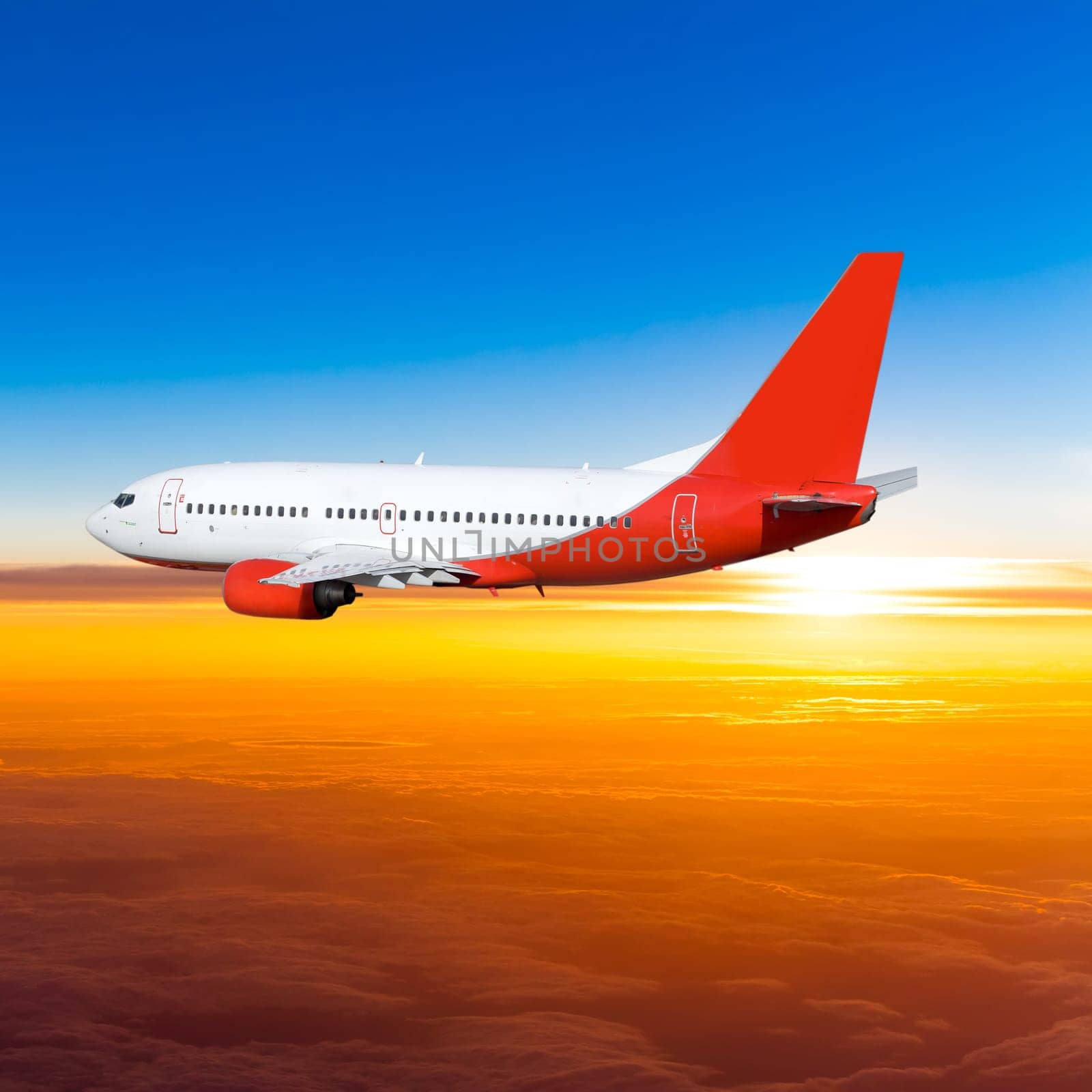 Airplane in the sky at sunset. A passenger plane in the sky