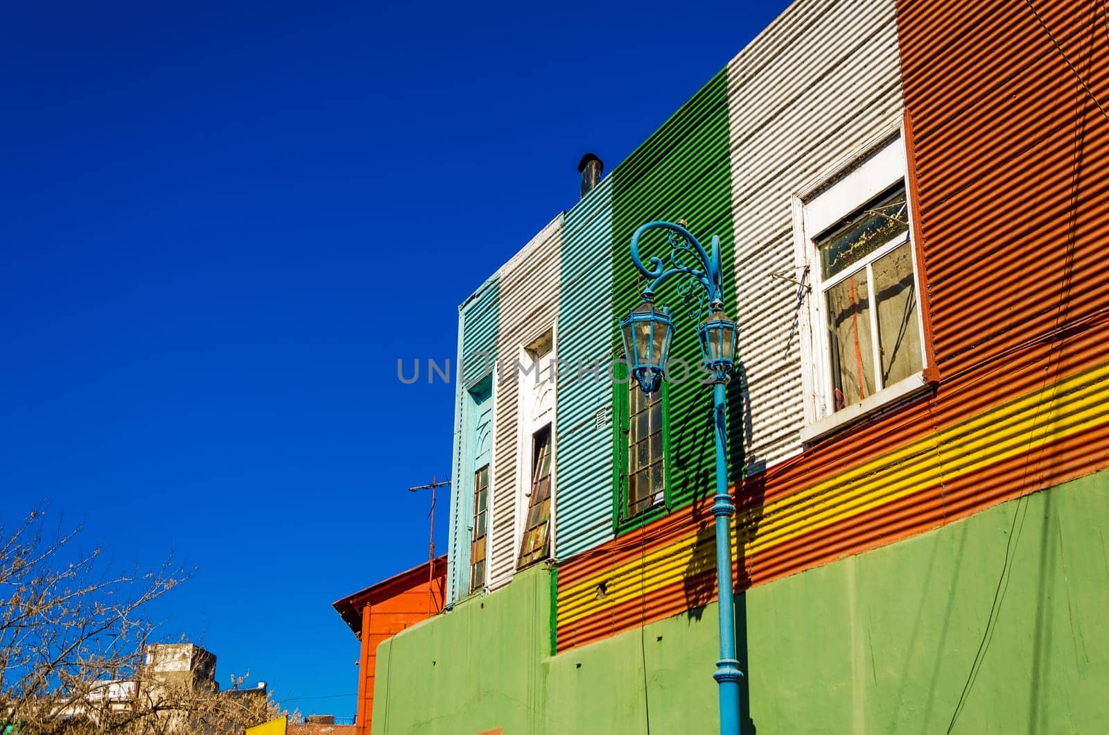 Blue lamppost against old building in La Boca neighborhood in Buenos Aires, Argentina