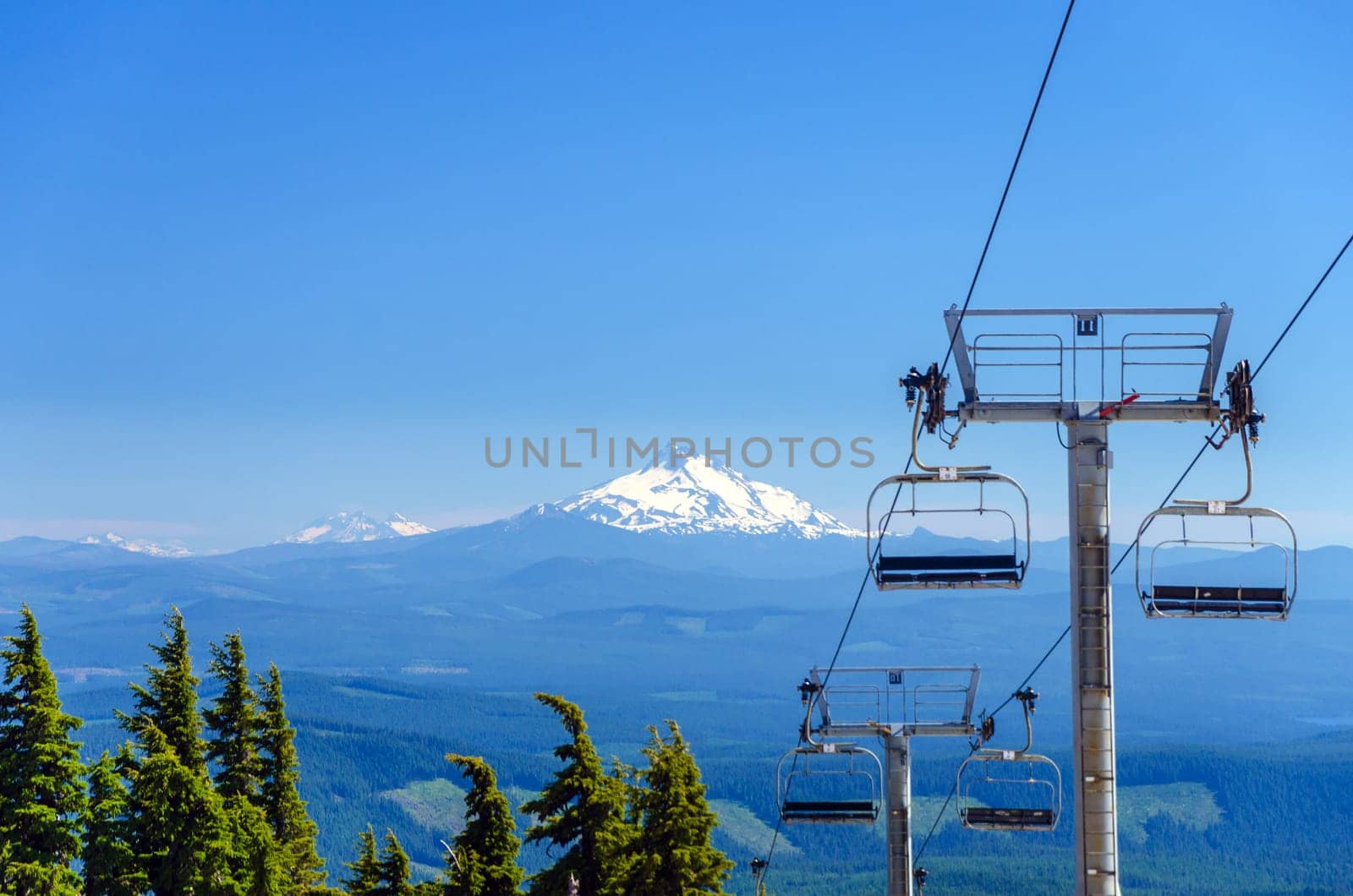View of chairlifts on Mt. Hood with Mount Jefferson in the background in Oregon