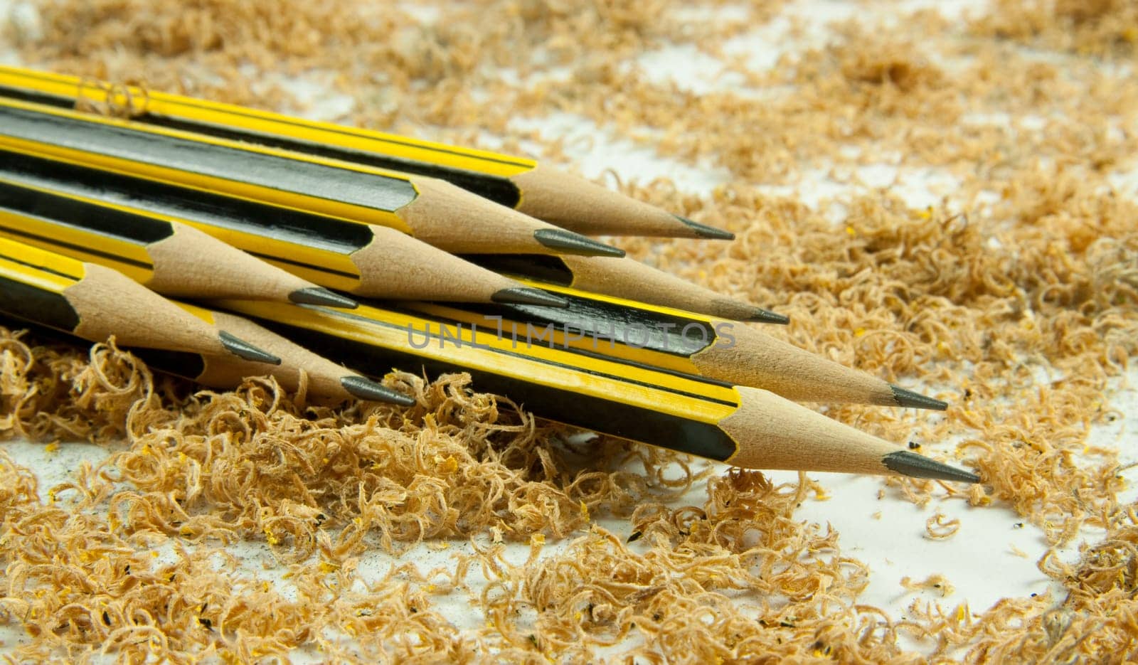 Wooden pencil with shavings isolated on white background