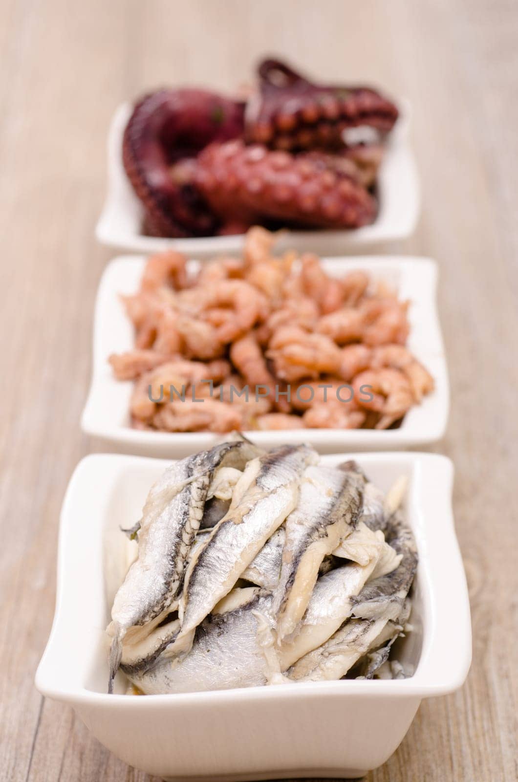 Antipasti anchovies in a white bowl of porcelain