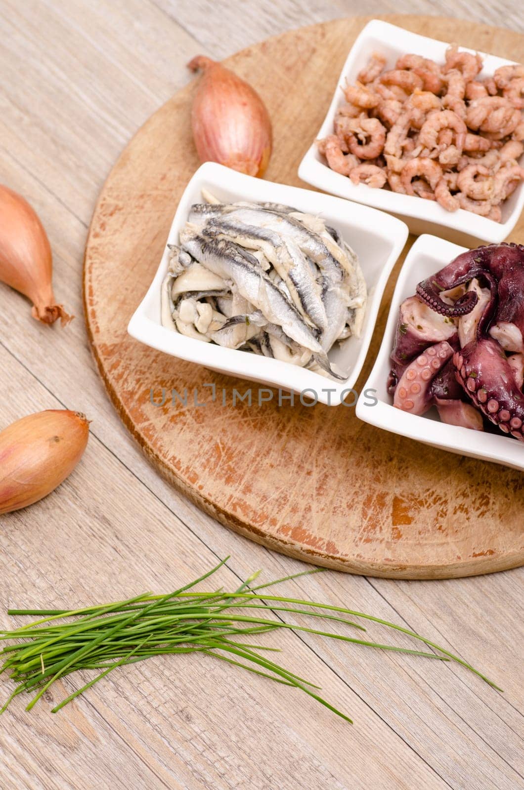 Seafood appetizers with onions and chives in portrait format