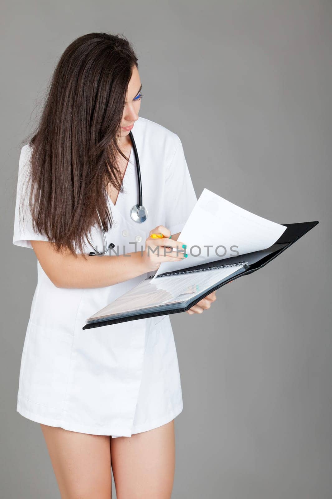 medical doctor woman with stethoscope. A female doctor with a folder