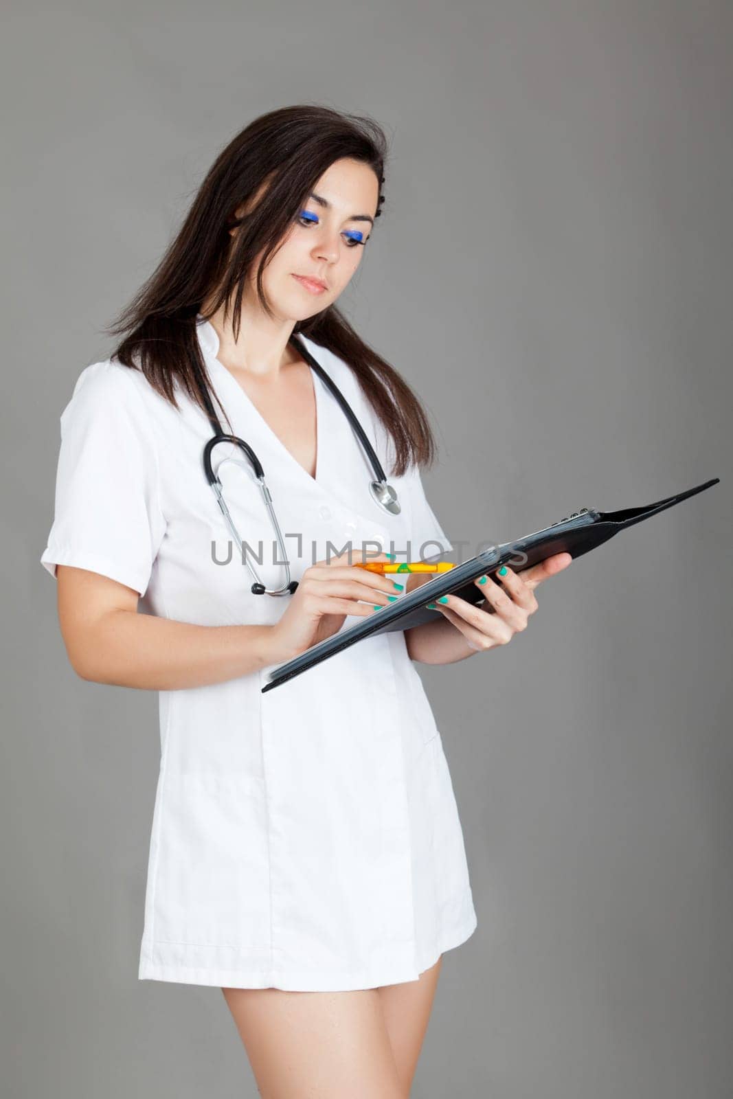 medical doctor woman with stethoscope. A female doctor with a folder