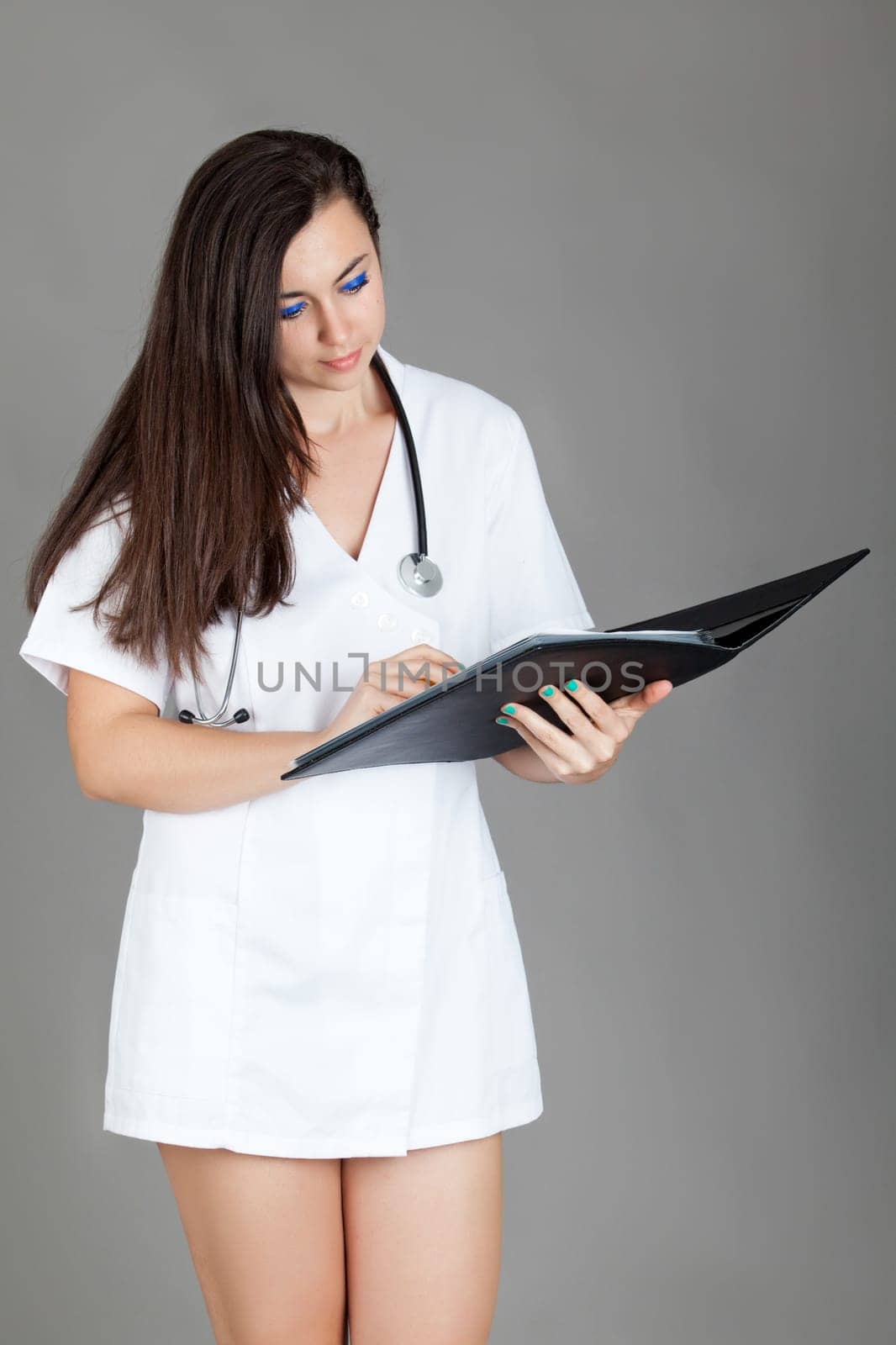 medical doctor woman with stethoscope. A female doctor with a folder
