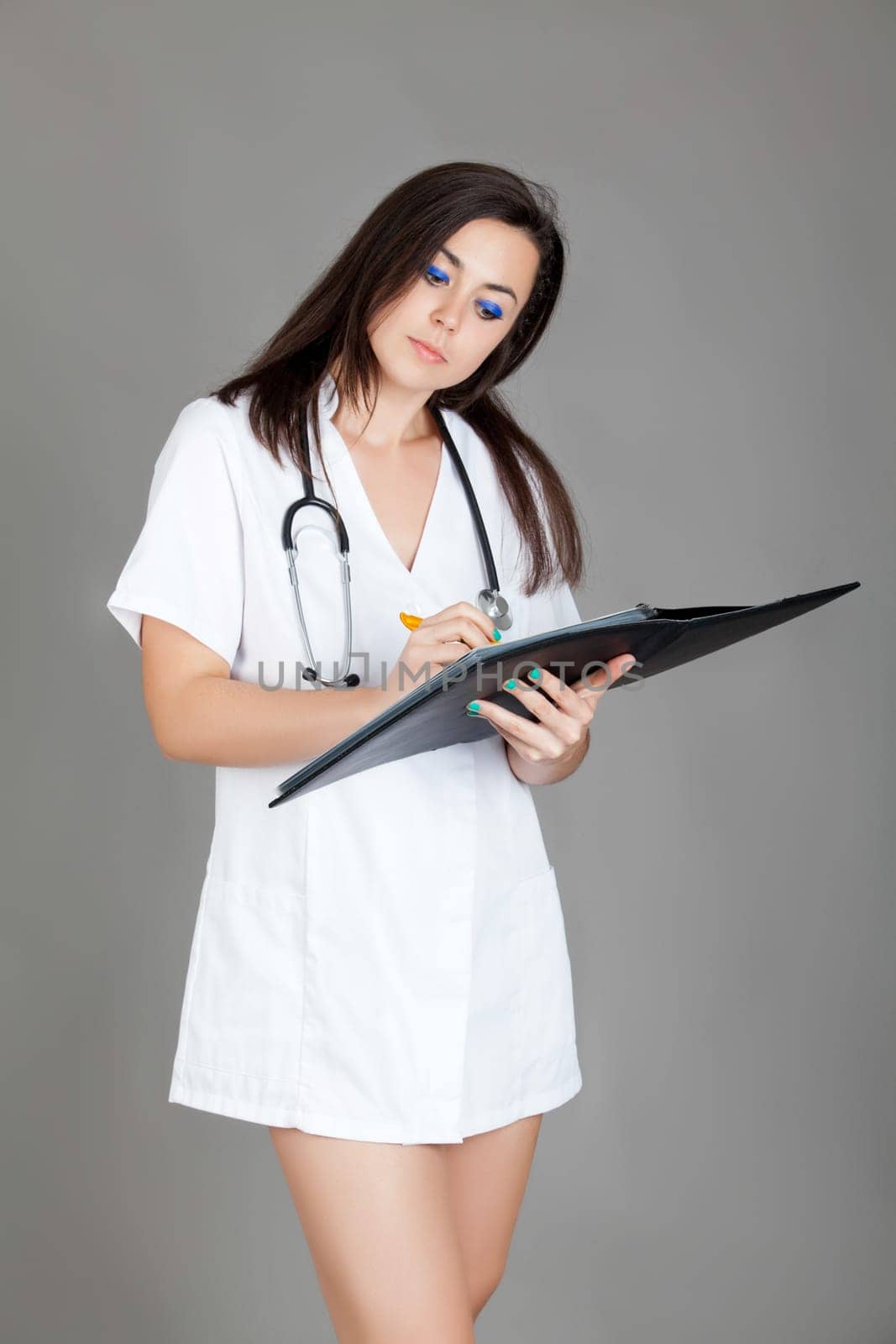 medical doctor woman with stethoscope. A female doctor with a folder