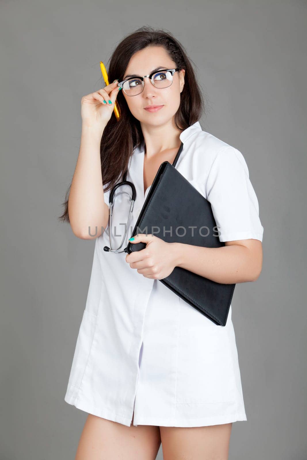 medical doctor woman with stethoscope. A female doctor with a folder