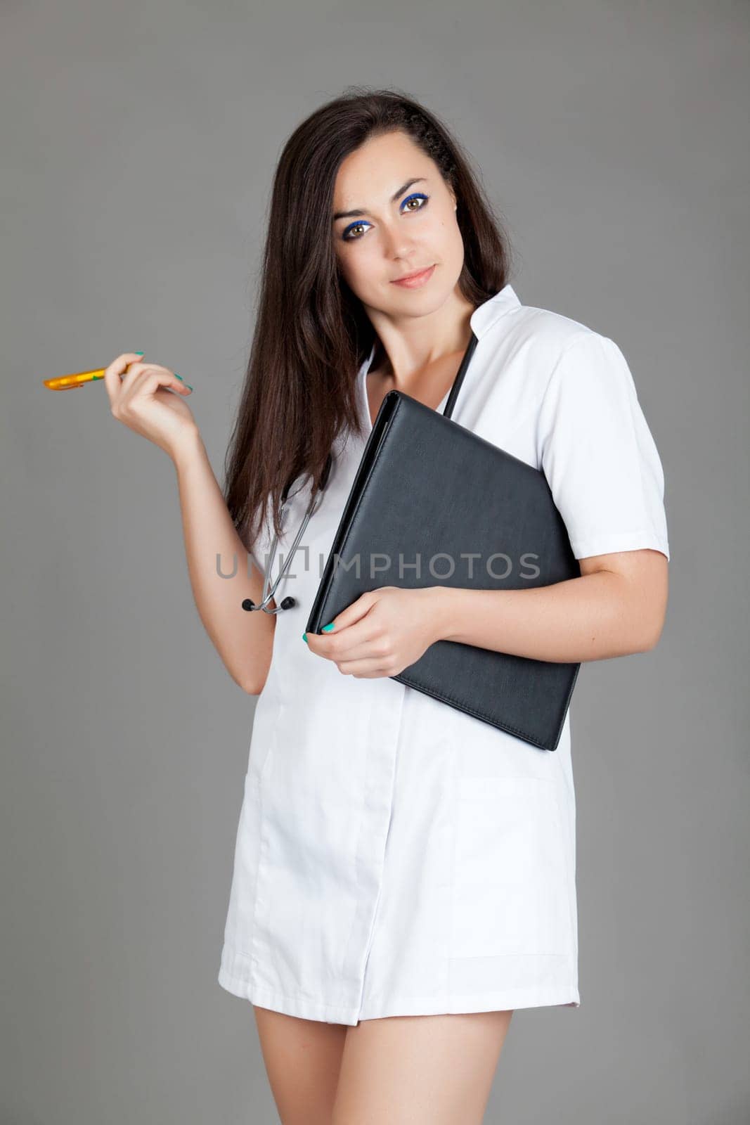 medical doctor woman with stethoscope. A female doctor with a folder