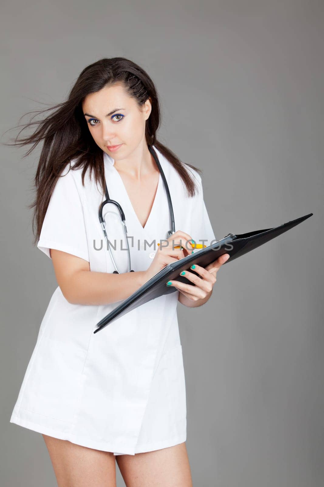 medical doctor woman with stethoscope. A female doctor with a folder