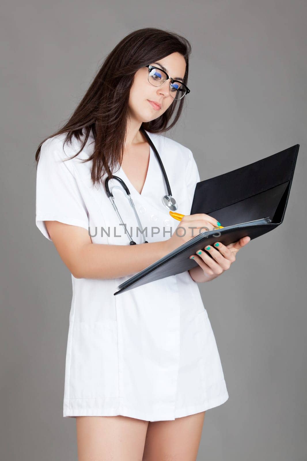 medical doctor woman with stethoscope. A female doctor with a folder