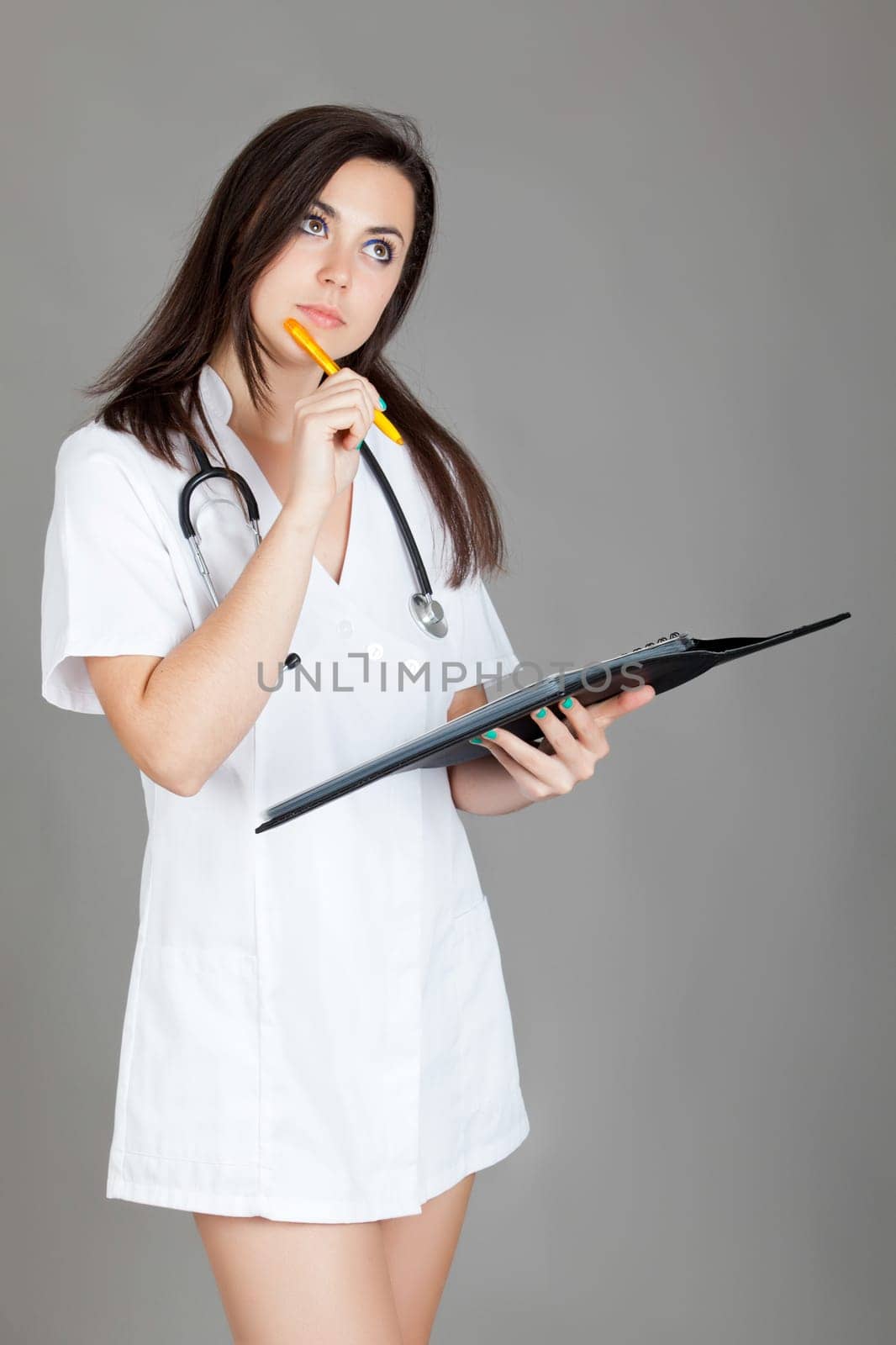 medical doctor woman with stethoscope. A female doctor with a folder