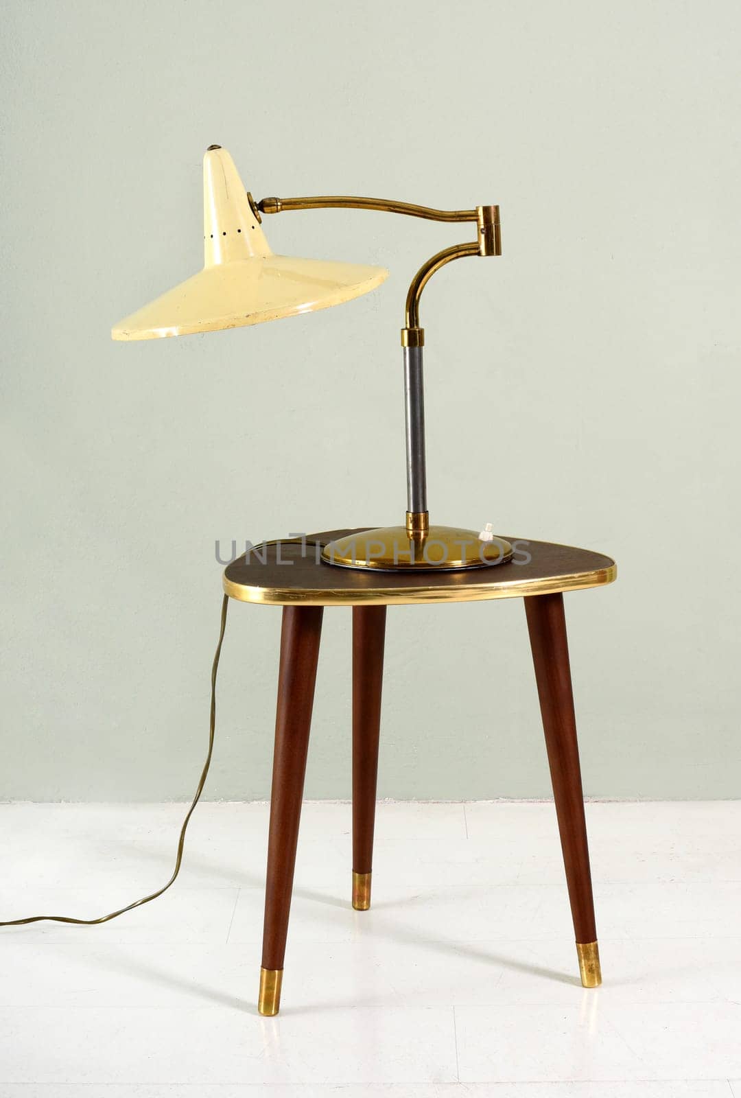 Vintage iron lamp over a wood and bass stool