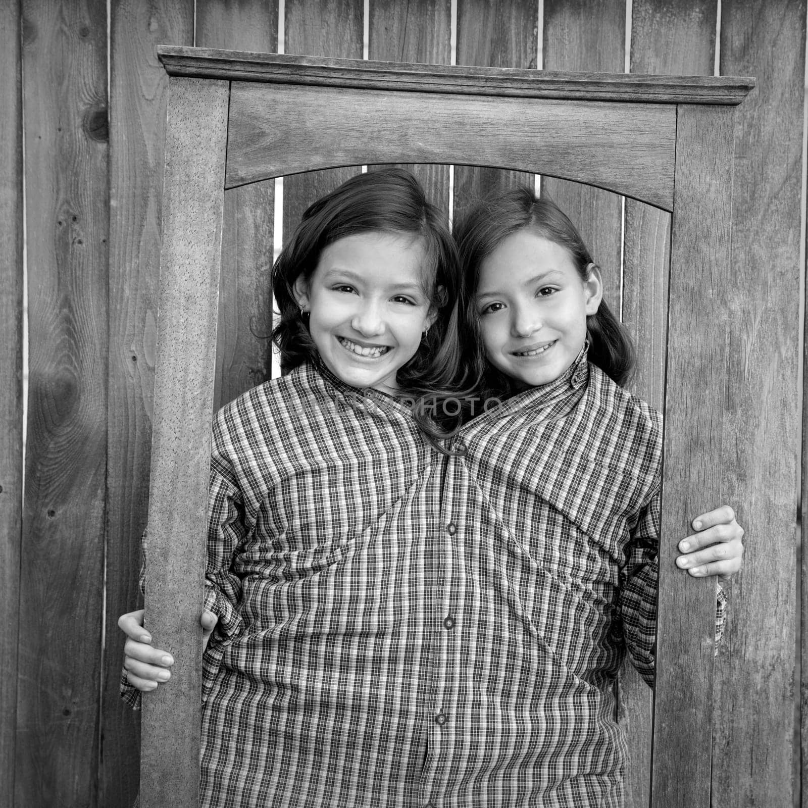 twin girls fancy dressed up pretending be siamese with dad shirt playing with grunge border frame