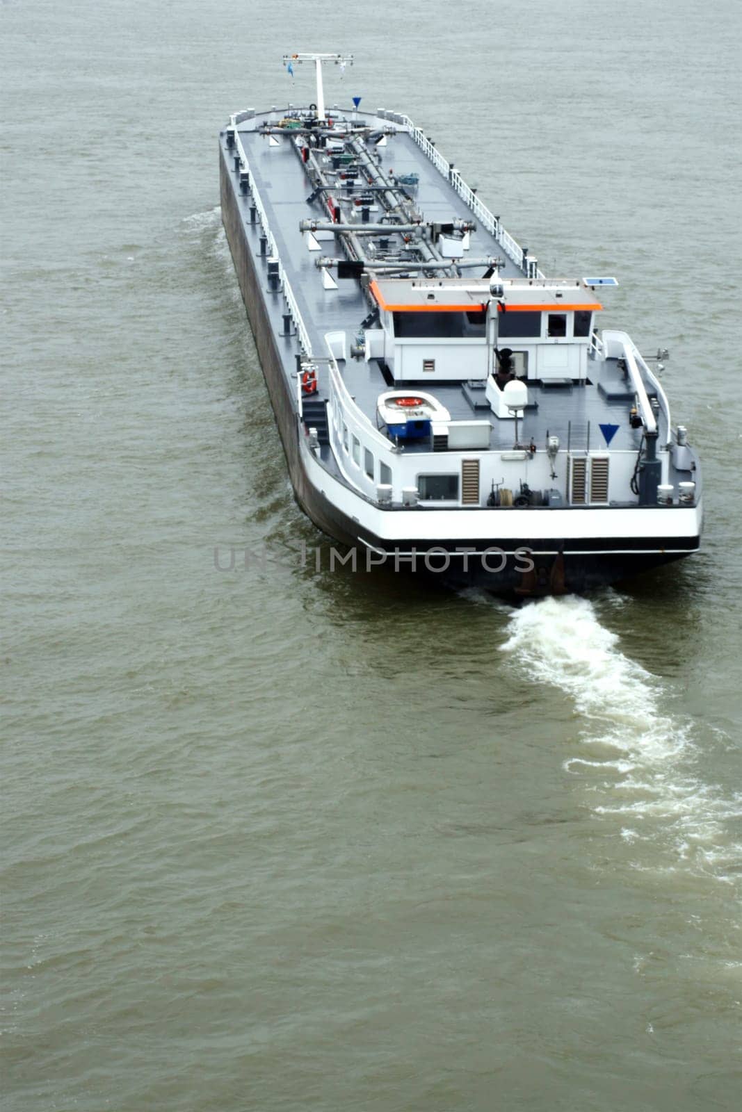 The photograph of a cargo ship via bird's eye view.
