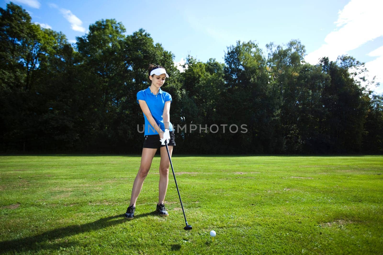 Woman playing golf on field
