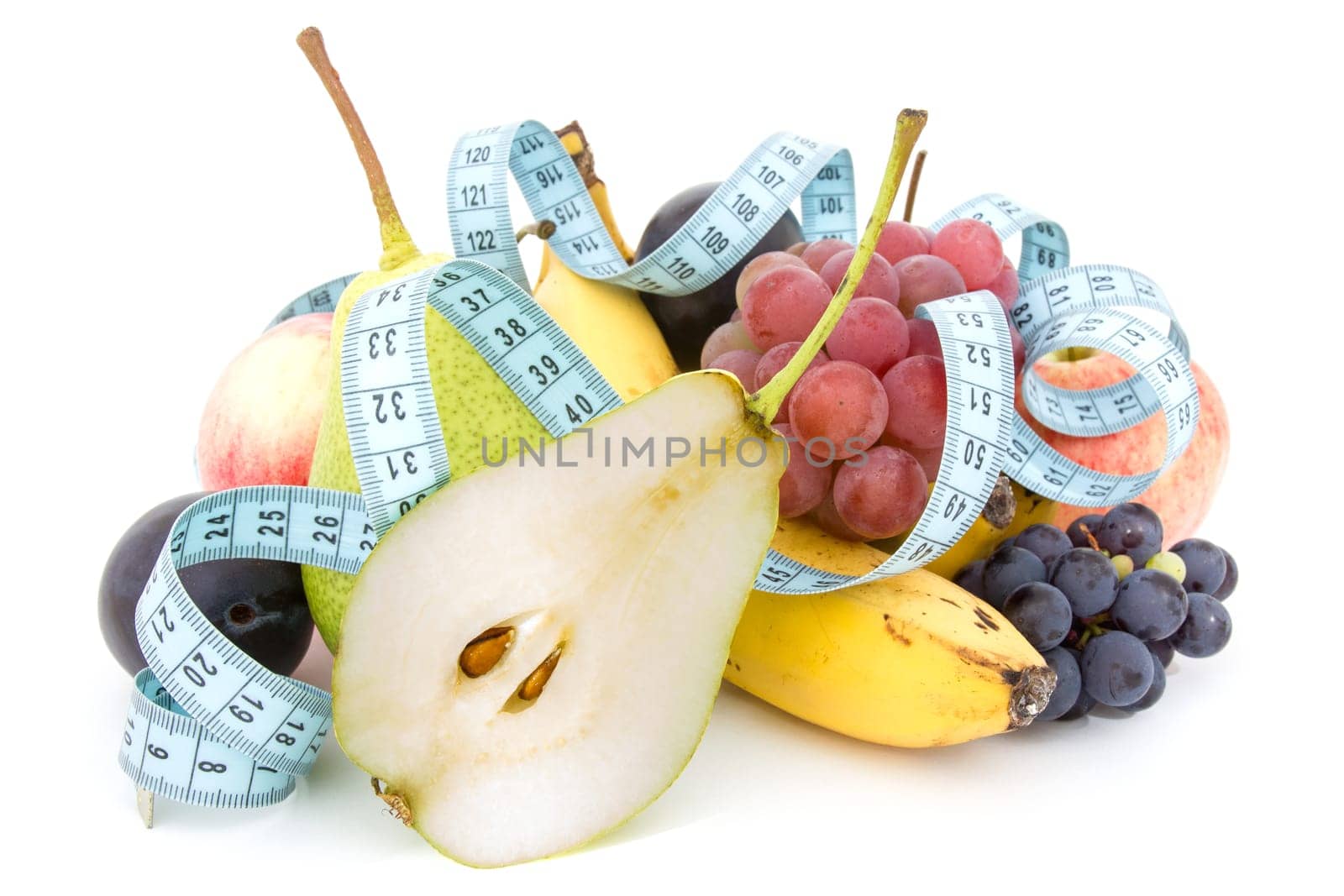 Measure tape and fruits composition over a white background