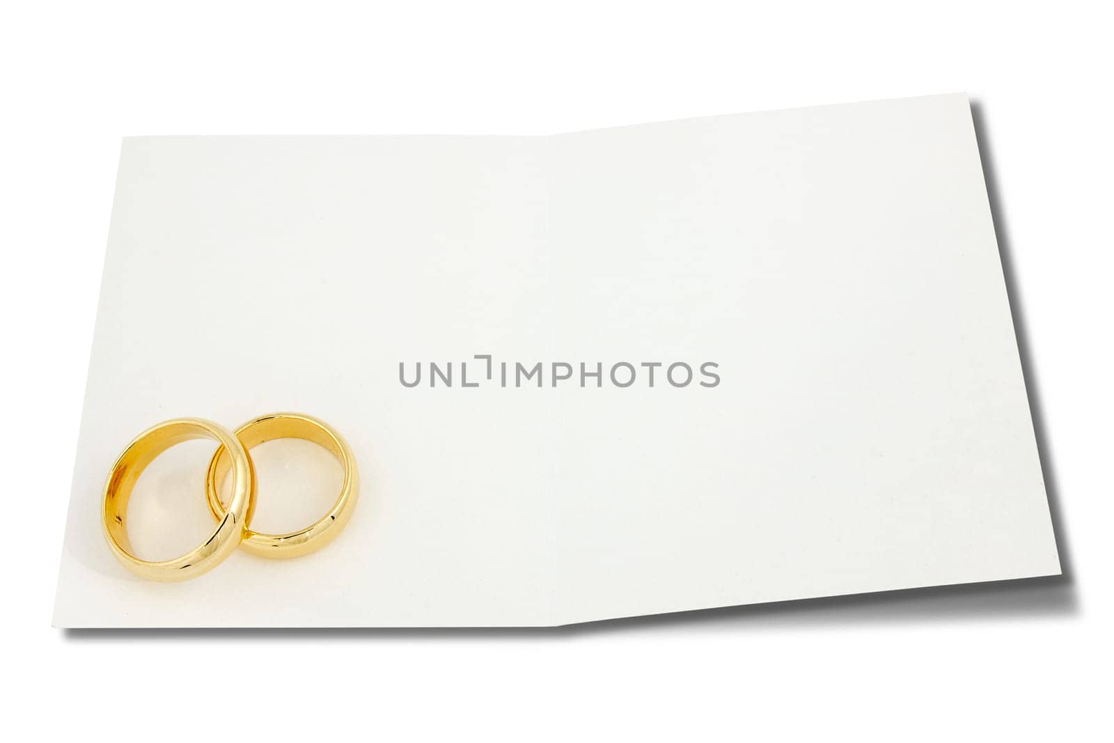 Wedding rings on the card for text over a white background