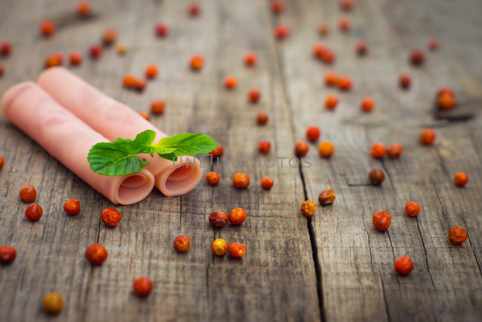 Fresh ham rolls with a mint leaf on wood background