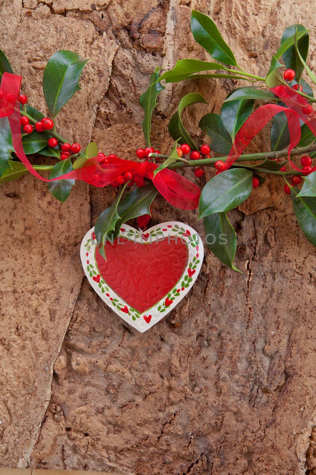 Rustic background with Christmas decorations and holly branches