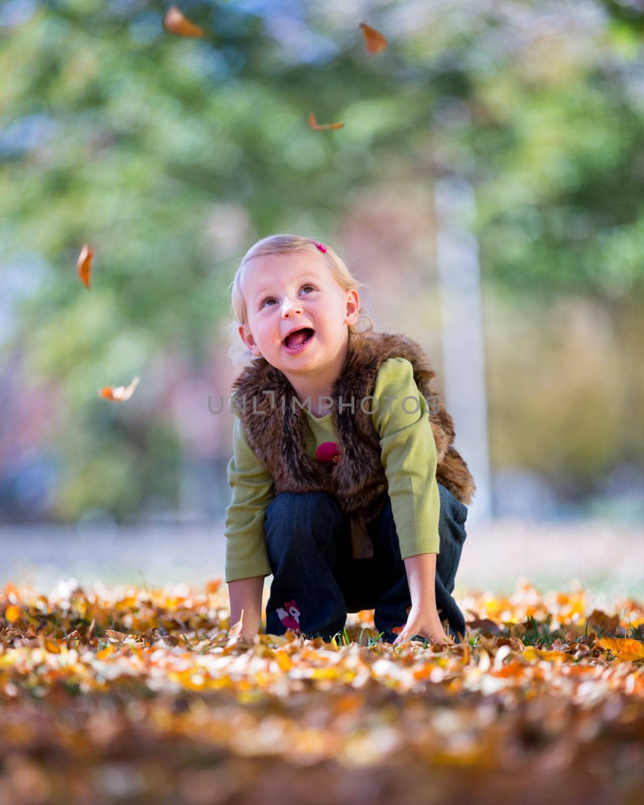 cute little girl with autumn leaves