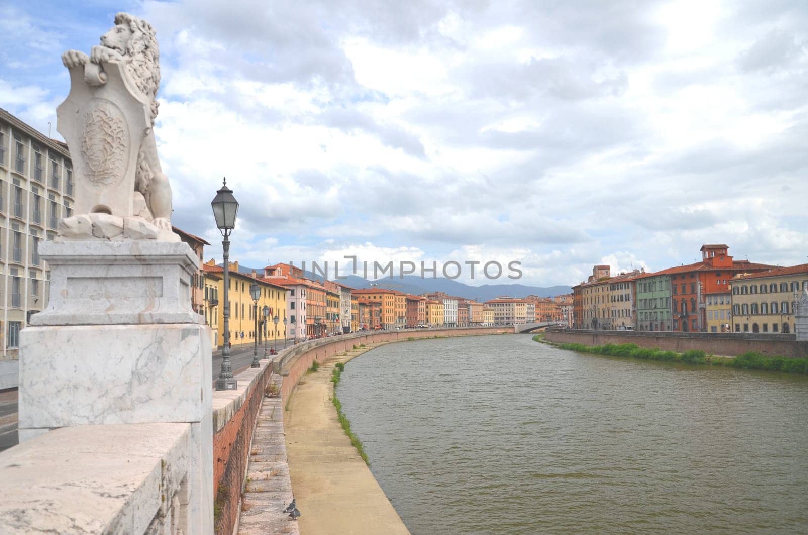Picturesque colorful historic buildings along Arno river in Pisa, Italy