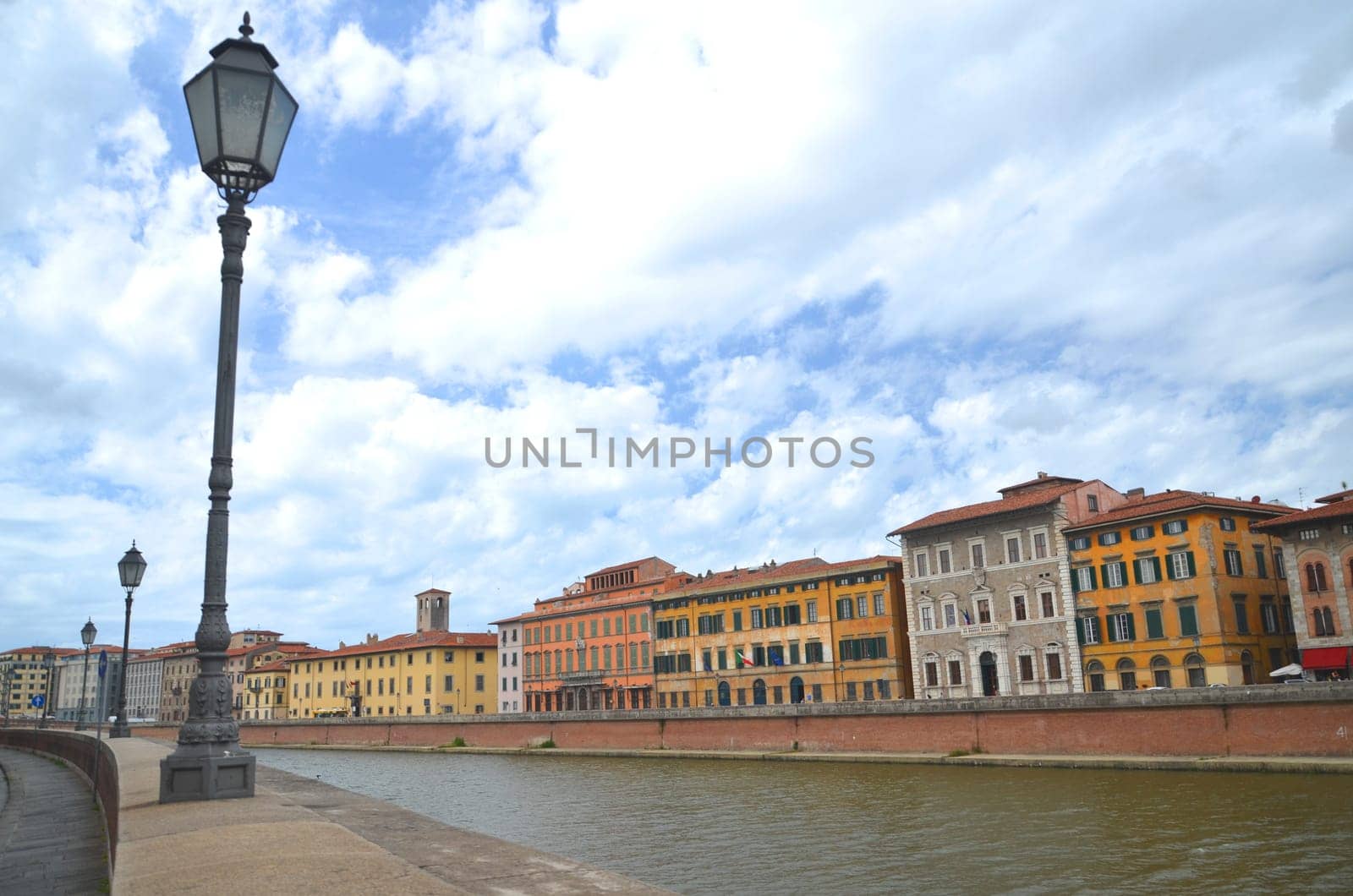 Picturesque colorful historic buildings along Arno river in Pisa, Italy