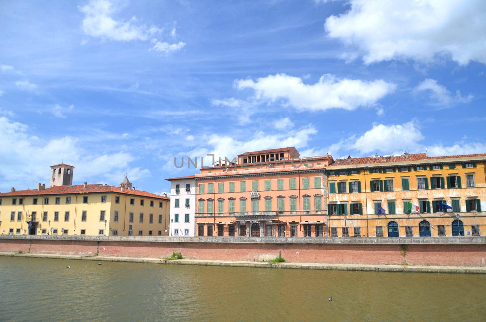 Picturesque colorful historic buildings along Arno river in Pisa, Italy