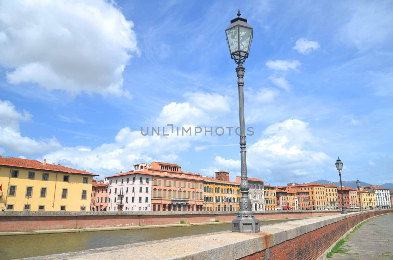 Picturesque colorful historic buildings along Arno river in Pisa, Italy