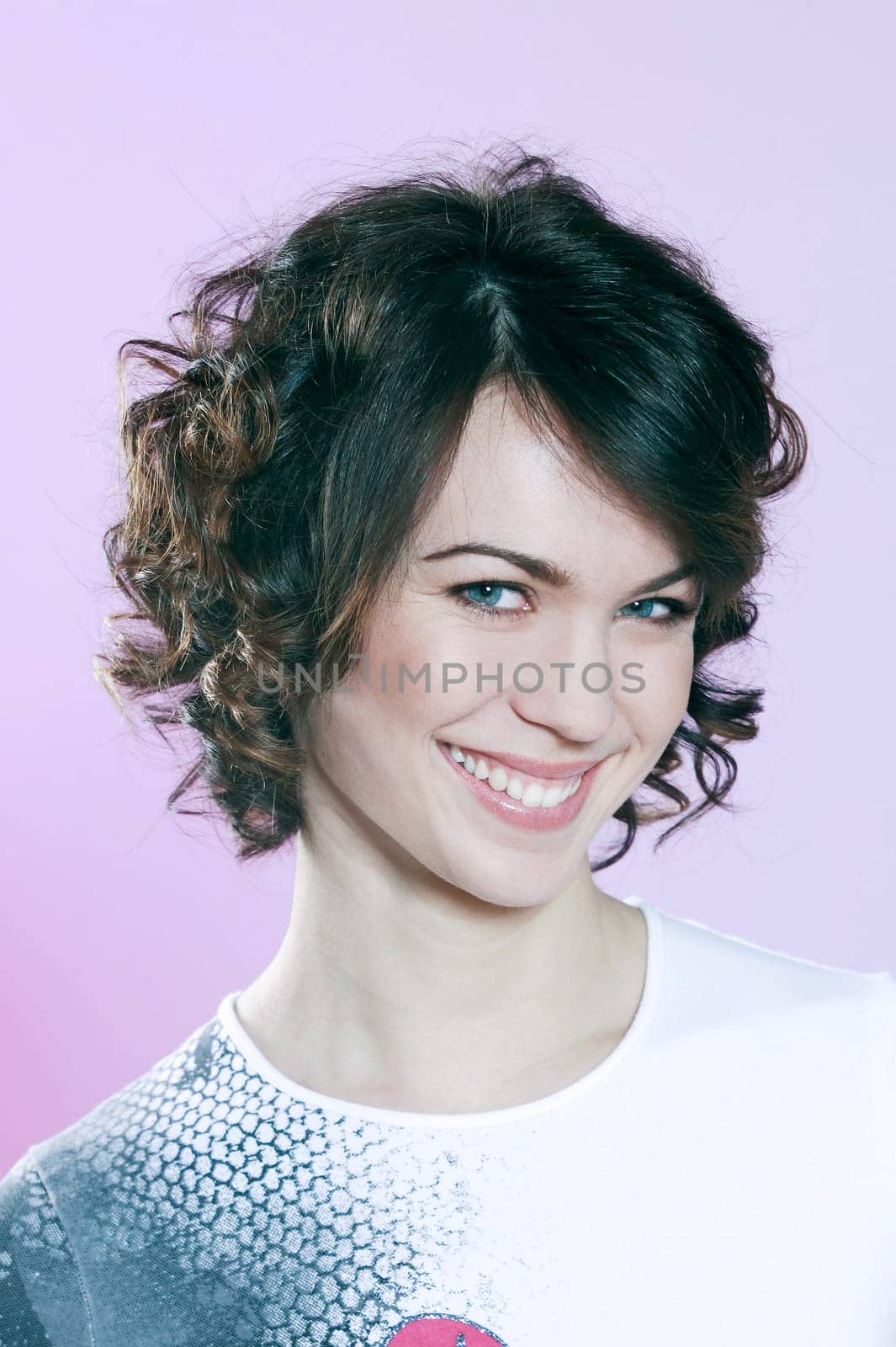 studio shots portrait of a beautiful caucasian young smiling woman on purple background