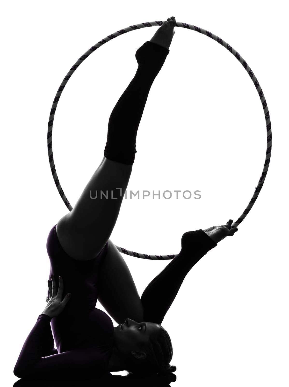 one caucasian woman exercising Rhythmic Gymnastics hula hoop  in silhouette studio isolated on white background