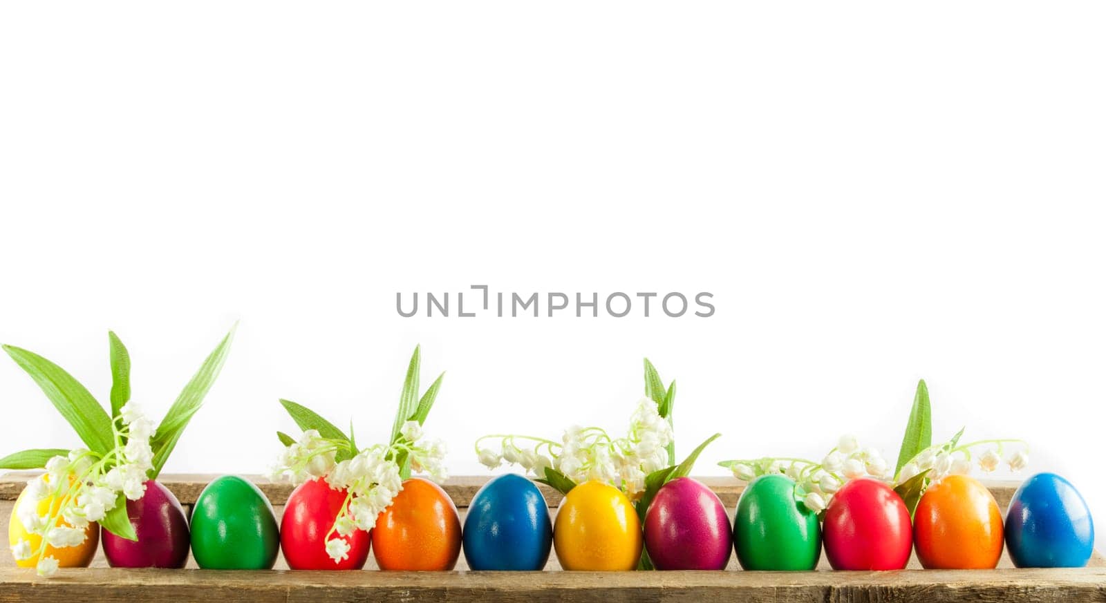 Colorful easter eggs on old wooden background. Easter concept. The colorful painted Easter eggs