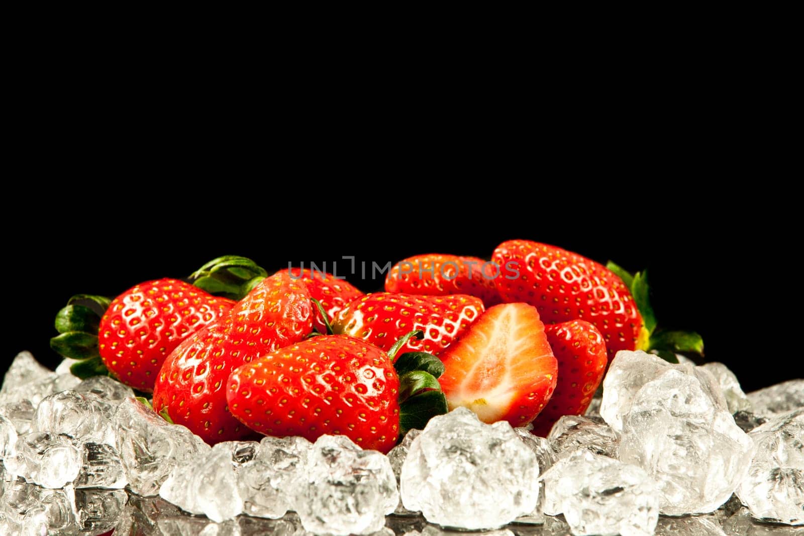 strawberry on black background.  strawberries with ice cubes on a black background. strawberry and ice
