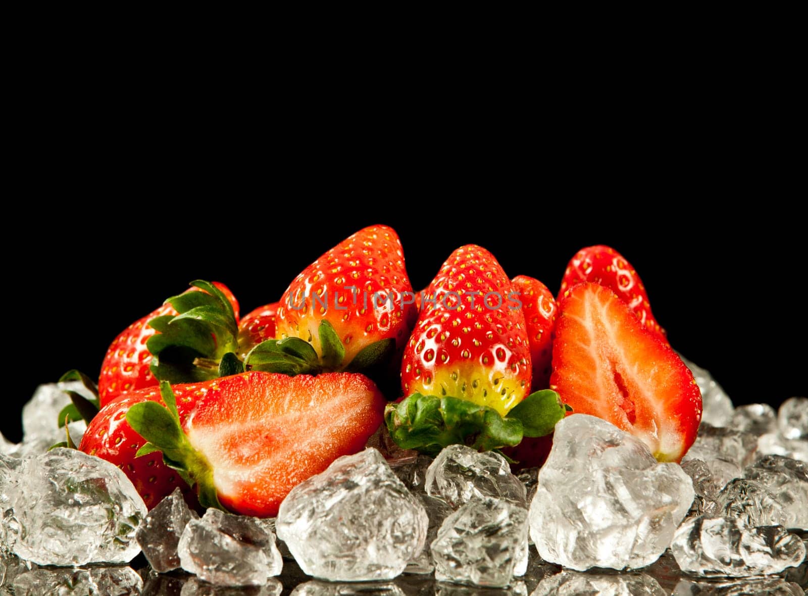strawberry on black background.  strawberries with ice cubes on a black background. strawberry and ice