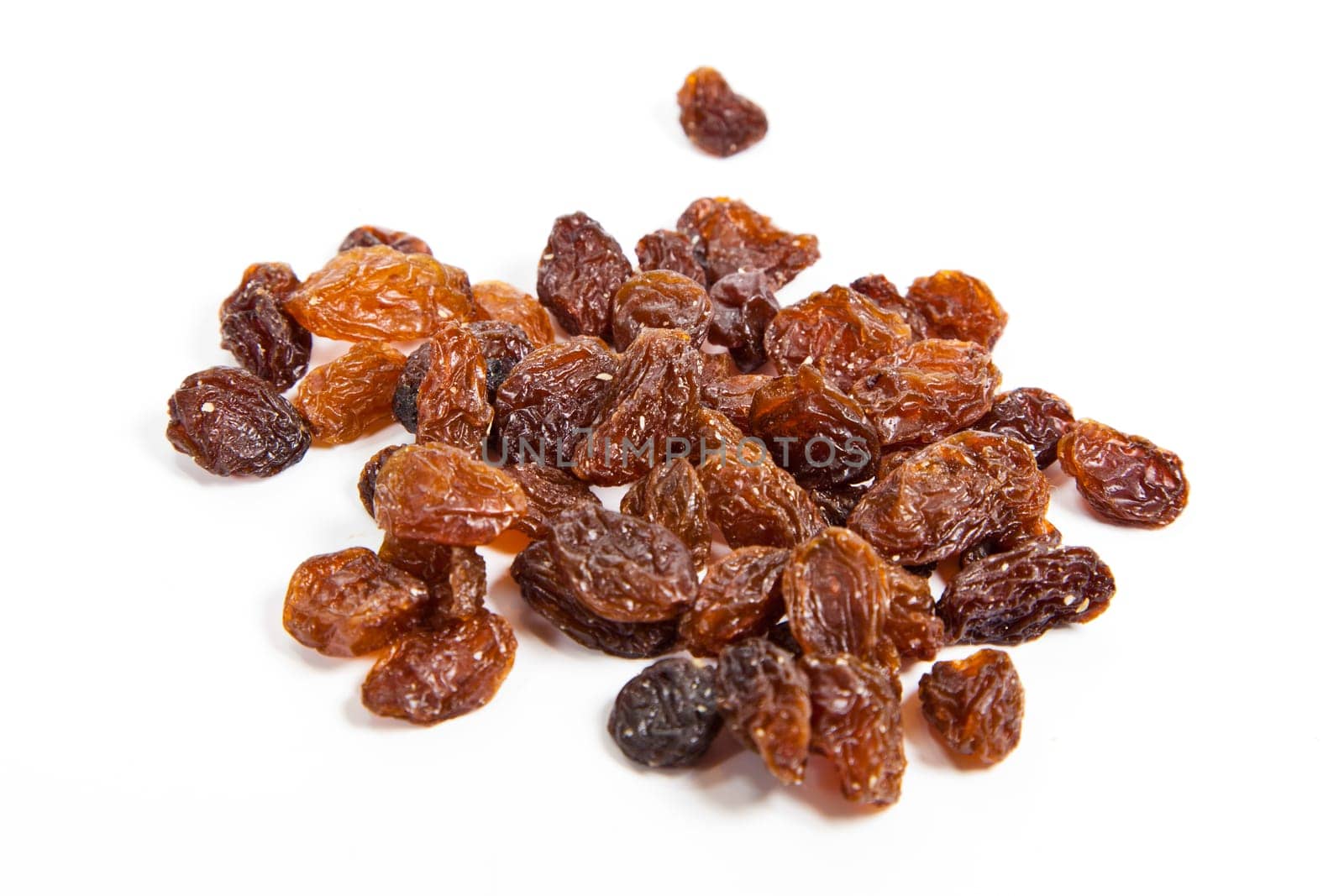 brown raisins on a white background