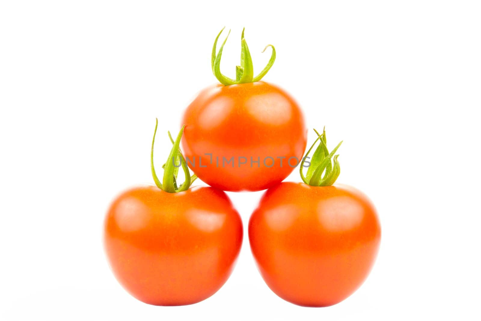 Three tomatoes stacked in pyramid shape